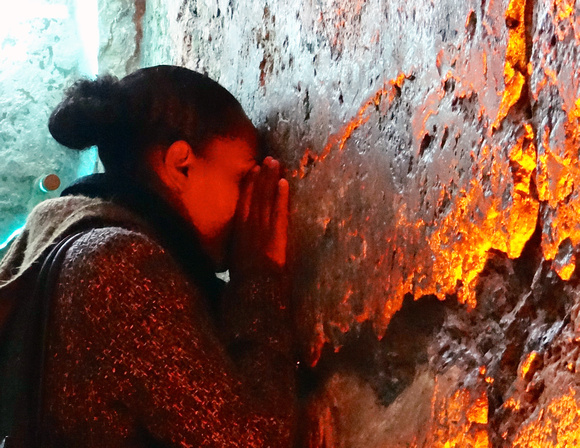 Woman praying at Western Wall's Inner Surface Jerusalem Israel